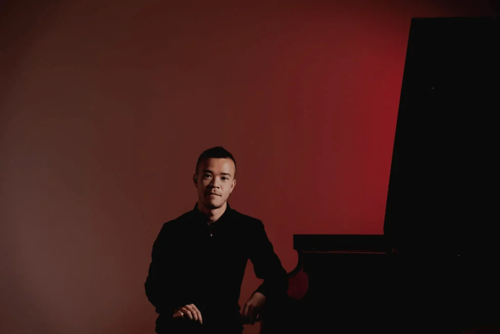 Portrait of Albert Lau sitting at the piano