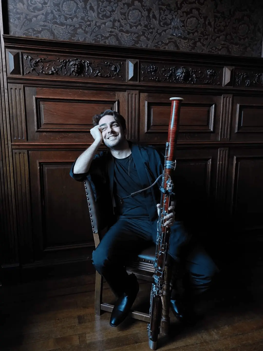 Mavroudes Troullos holding bassoon and smiling